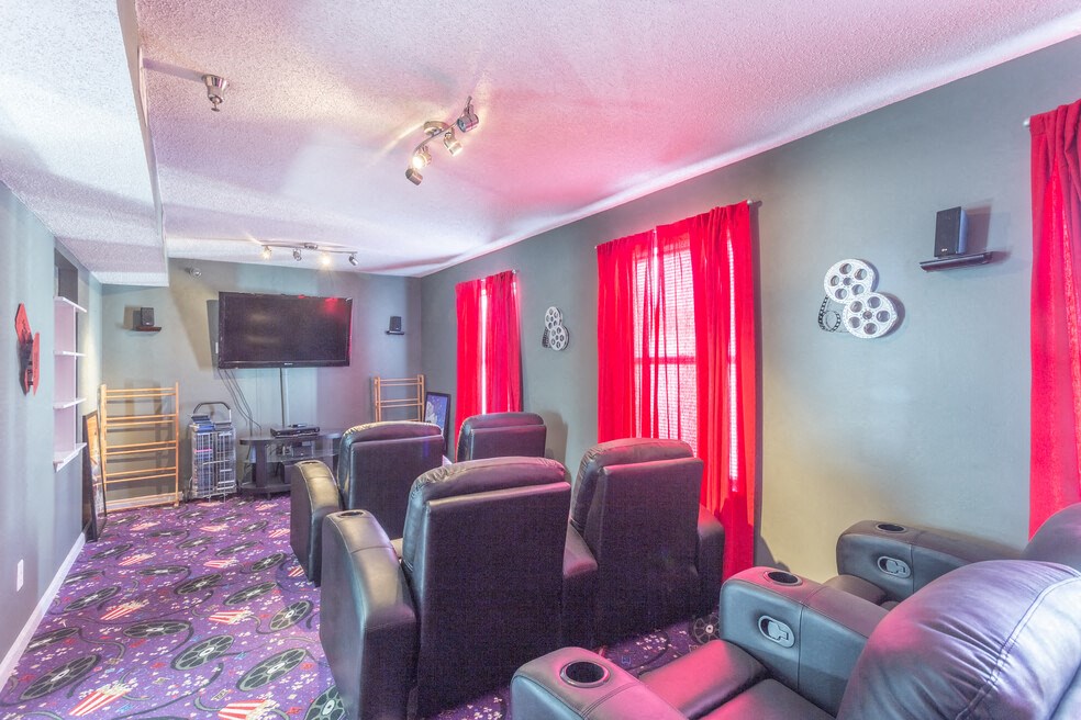 A room with a purple carpet and red curtains.
