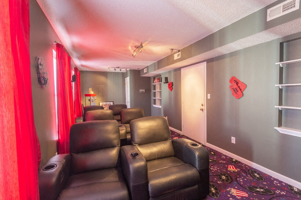 A row of black leather recliner chairs are lined up in a room.