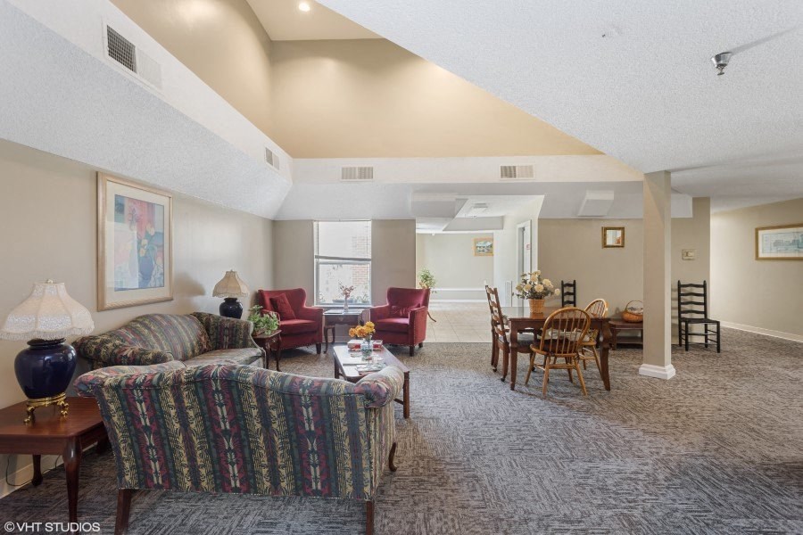 A living room with a sofa, chairs, and a dining table.