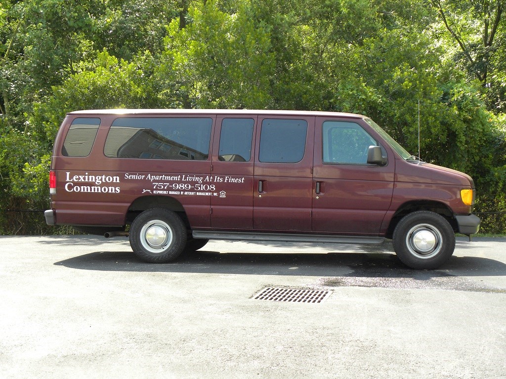A red van with the text "Lexington Commons" on the side is parked in a lot.