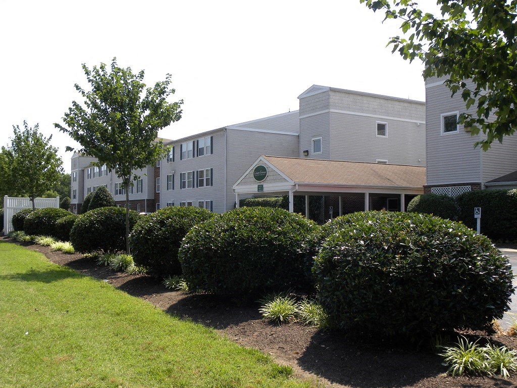 A building with a green lawn in front of it.