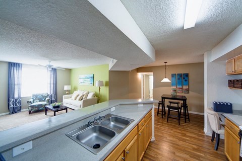 A kitchen with a sink and a dining table.