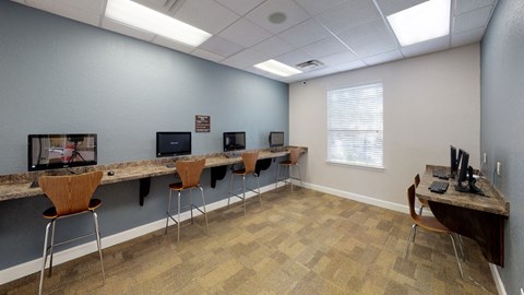 A room with a long table and chairs.