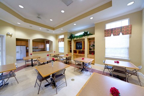 A dining room with a table and chairs.