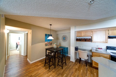 A kitchen with a table and chairs in the middle of the room.