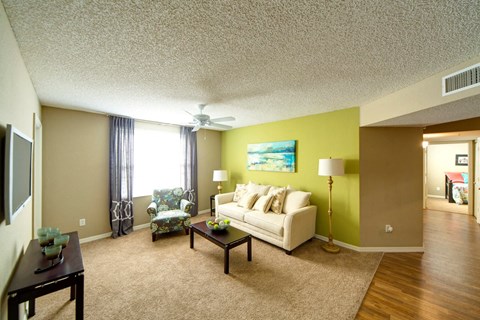 A living room with a couch, chair, and coffee table.