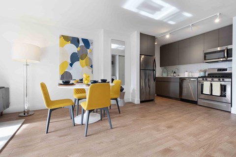 A modern kitchen with a yellow chair set.