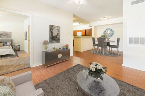 A modern living room with a grey coffee table and a grey sofa.