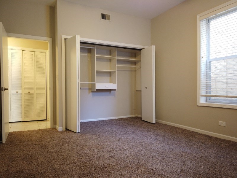 A room with a brown carpet and a white door.
