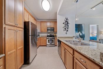 A kitchen with wooden cabinets and granite countertops.