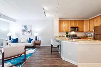 A kitchen with a white counter and wooden cabinets.