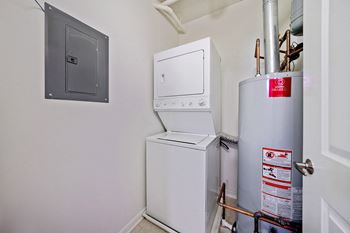 A white washing machine and dryer in a small room.