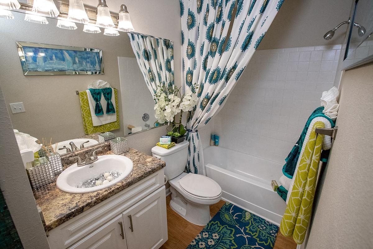 Newly renovated bathrooms feature wood-style flooring and large mirrors Newly renovated bathrooms feature wood-style flooring and large mirrors