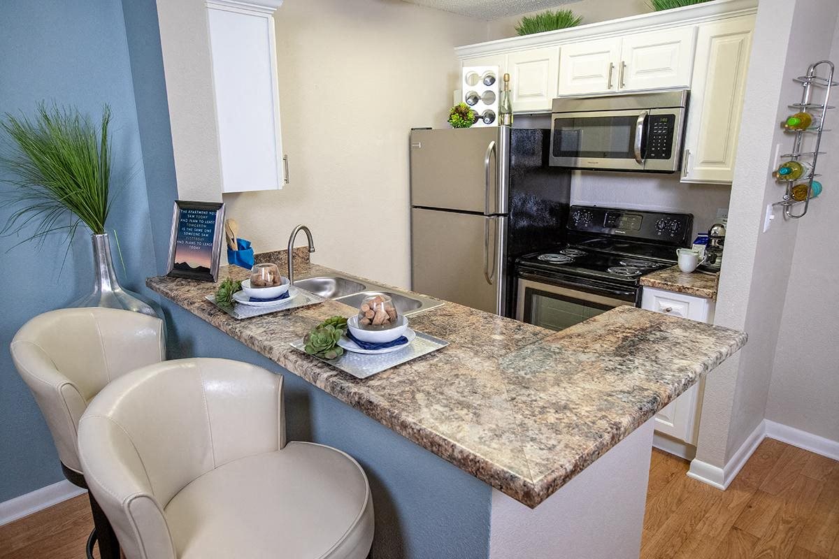 Newly updated kitchens with white cabinetry, granite countertops, and stainless steel appliances Newly updated kitchens with white cabinetry, granite countertops, and stainless steel appliances