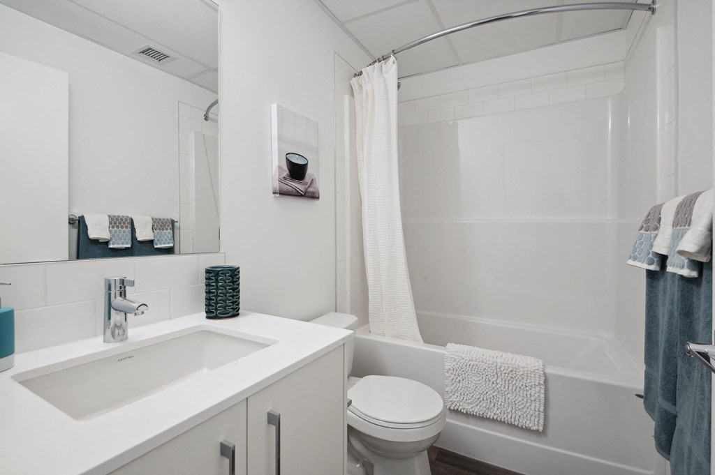 a small bathroom with a sink toilet and shower
