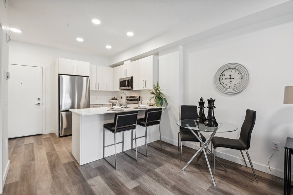 an open kitchen and dining area with a table and chairs