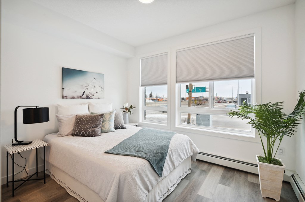 a bedroom with a bed and a large window