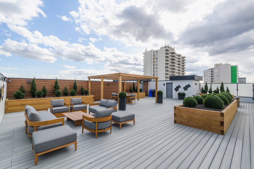 A wooden deck with chairs and a table.