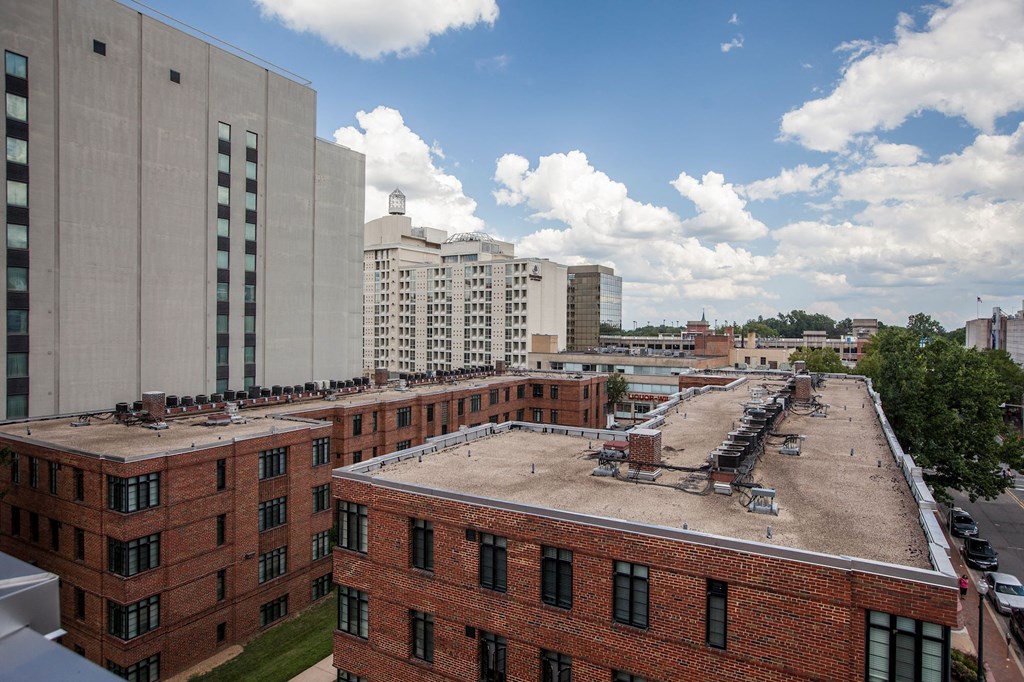 A view of a cityscape with buildings and cars.
