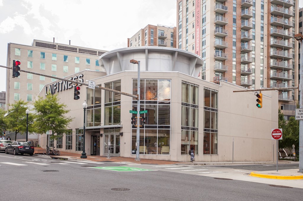 A street view of a building with a sign that reads "Fitness".