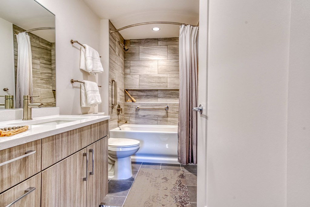 a bathroom with a toilet and a shower and a sink