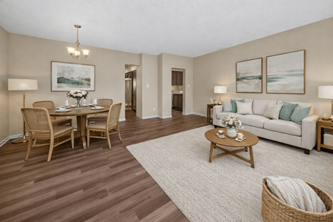 A living room with a dining table and chairs.