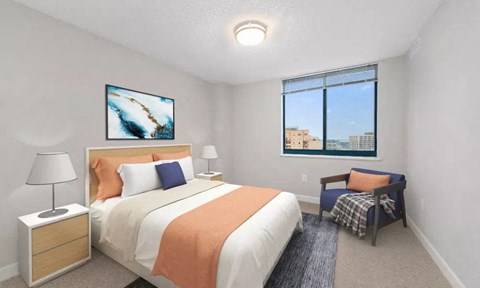 A bedroom with a large bed and a painting on the wall.