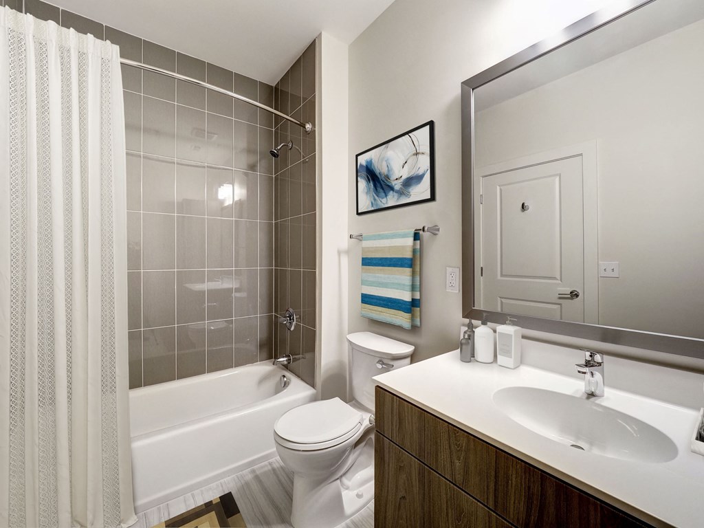 A bathroom with a white toilet, a white sink, and a white bathtub.