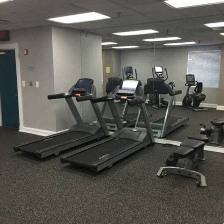 A gym with treadmills and elliptical machines.
