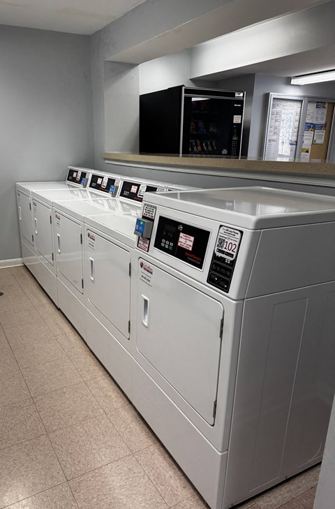 A row of washing machines in a laundromat.