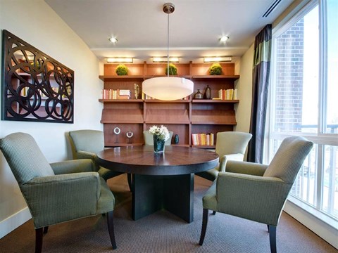 A modern dining room with a round table and chairs.