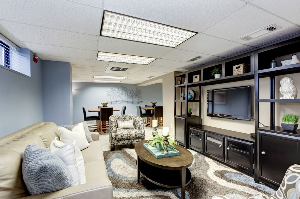A living room with a couch, chairs, and a coffee table.