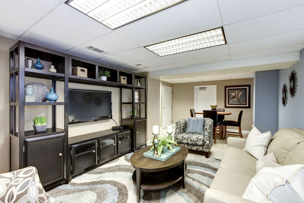 A living room with a white couch and a coffee table.