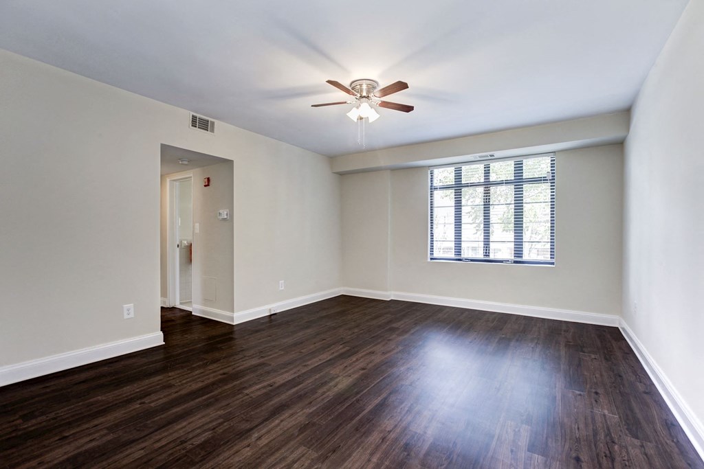 A room with a ceiling fan and a window.