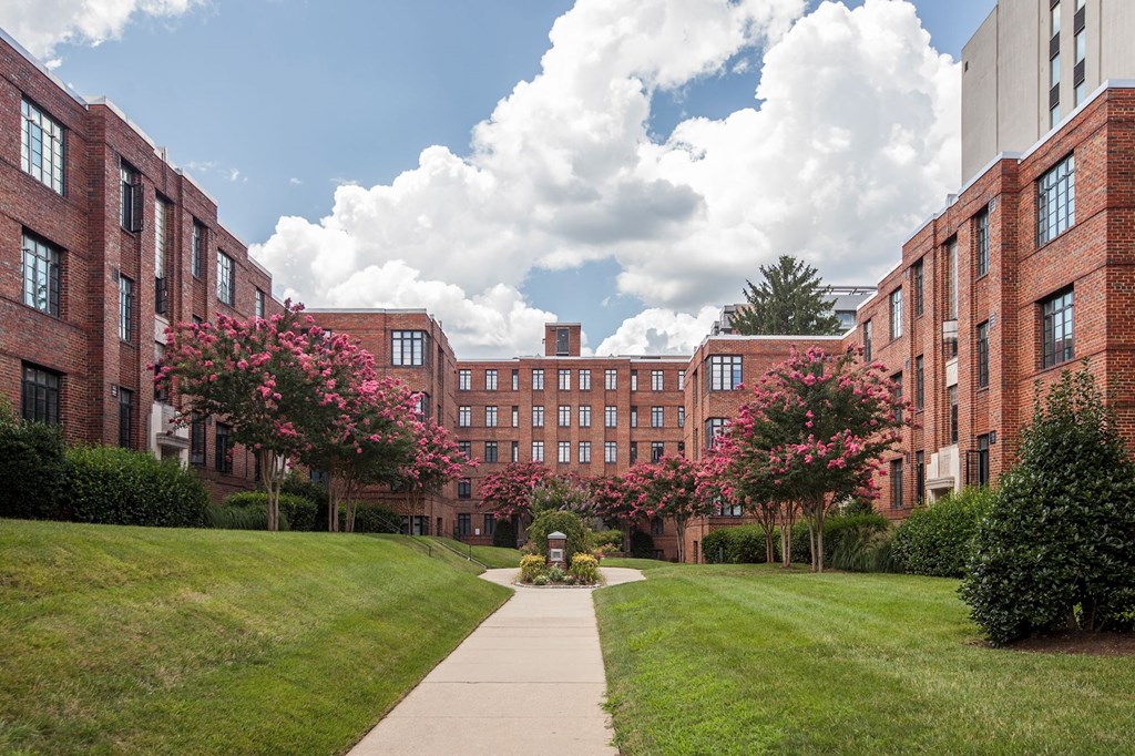 A long building with a walkway in front of it.