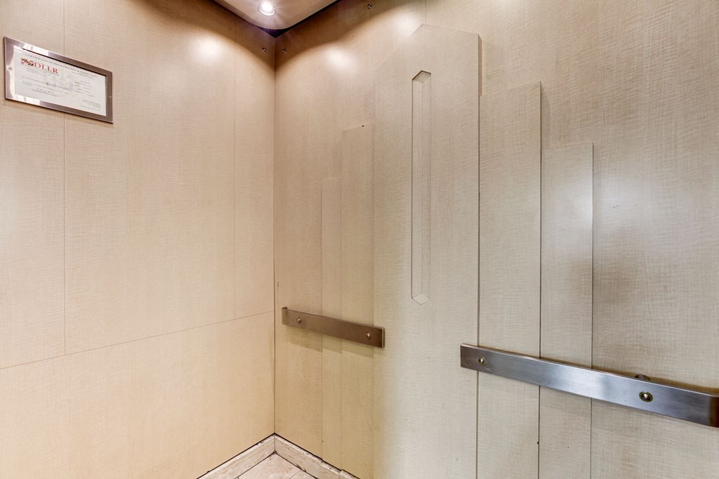 A metal hand rail on a wall.