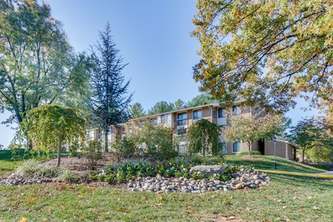 A large building with a landscaped front yard.