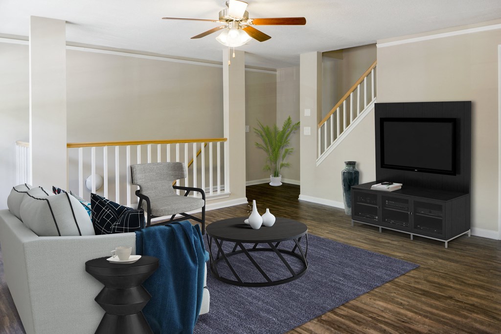 A living room with a white couch and a black coffee table.
