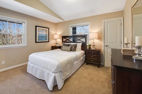 A bedroom with a large bed and a window.