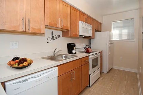 A kitchen with wooden cabinets and white appliances.