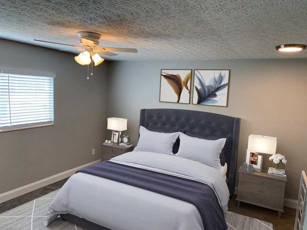 a bedroom with a bed and a ceiling fan