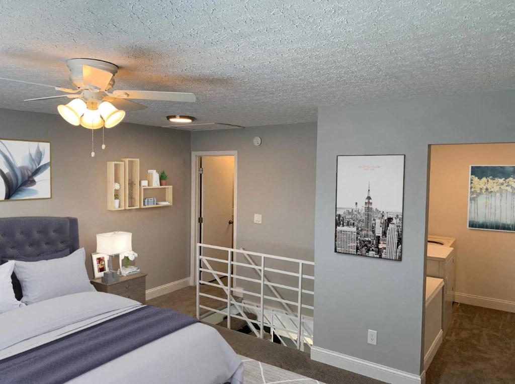 a bedroom with a bed and a ceiling fan