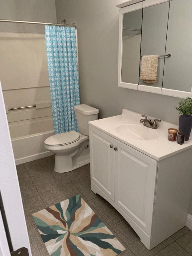 a bathroom with a toilet and a sink and a shower