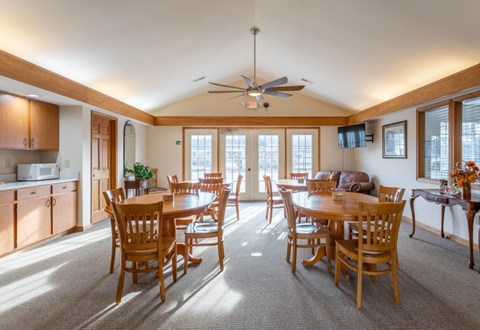A sunny day in a spacious dining room with a table set for six.