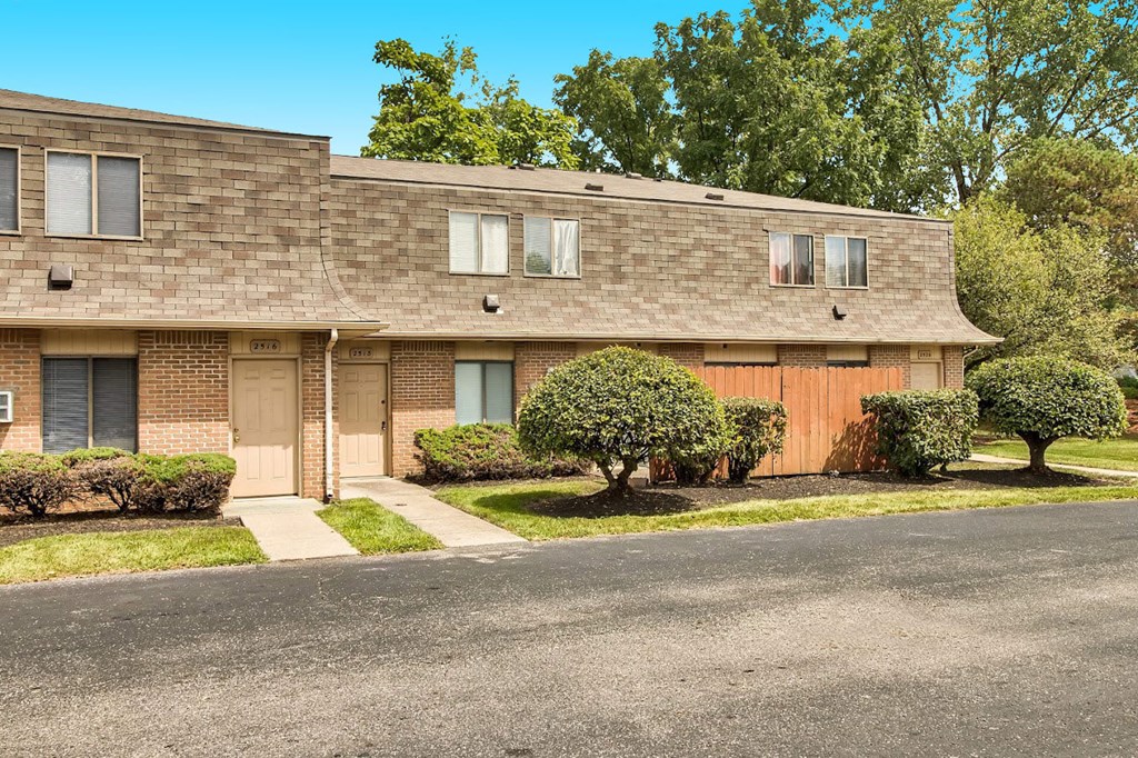 a brick apartment building with a street in front of it