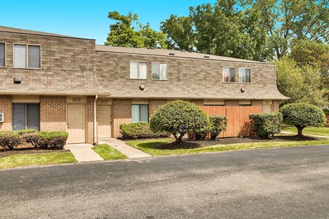 a brick apartment building with a street in front of it