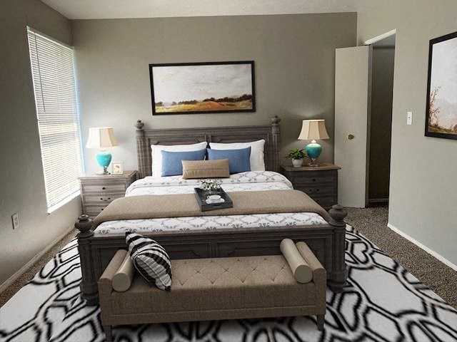 a bedroom with a large bed and a zebra rug