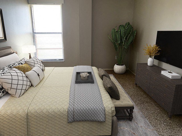 a bedroom with a bed and a tv