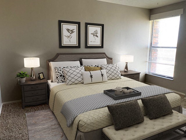 a bedroom with a bed and two lamps and two pictures on the wall