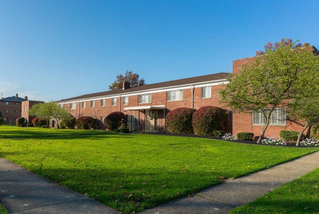 a brick building with a lawn in front of it